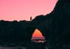 silhouette of man on rock walking during nightime